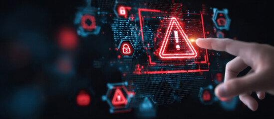 Cybersecurity alert interface with hand interacting with digital warning symbols and data threat indicators on futuristic screen concept. 
