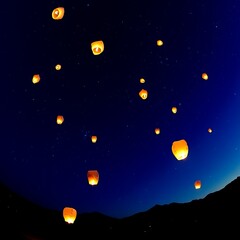 Fototapeta premium Thousands of bright paper lanterns ascend into the dark night sky over mountains