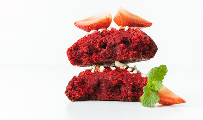 Close up shot of broken in half fresh chocolate American red chip cookie decorated with...