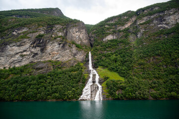The famous and impressive waterfall The Suitor (Friaren) dropping down the rocks into the Geiranger Fjord, Norway