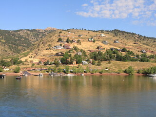 Homes on a Mountain Hillside with Lake and Boats in the Summer