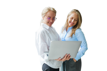 Two women collaborate happily with a laptop, showcasing creativity and teamwork 