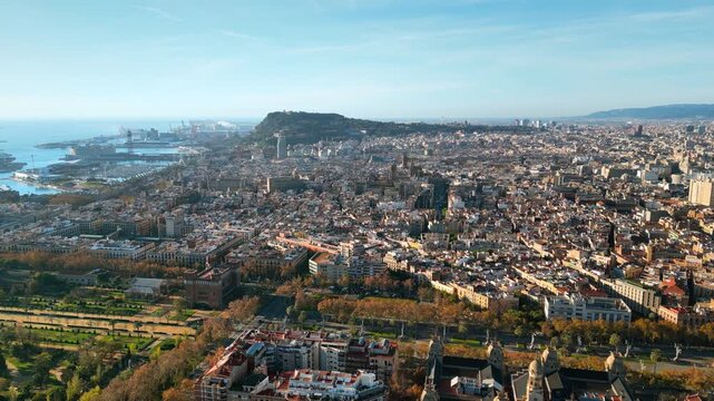 Aerial drone view of Barcelona, Spain, featuring Montjuic hill, the bustling Port of Barcelona, and the historic city center