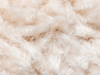 Close up of soft beige wool fiber texture in macro view