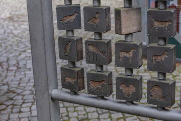 Metallic interactive art installation with engraved animal silhouettes on rotating blocks in Hann Münden, Germany