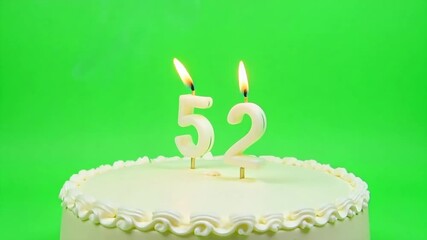 Celebrate a milestone with this vibrant birthday cake featuring lit candles for number 52, perfect for anniversaries and special occasions.