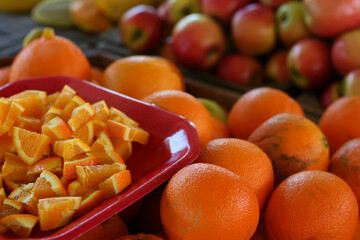 Fresh Oranges and Sliced Fruit at Market
