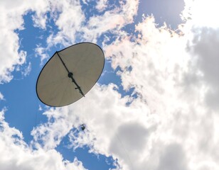Large light-colored kite in blue sky