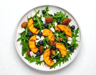 Grilled peach and blueberry salad with feta, nuts, and arugula