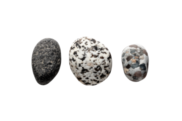 Three smooth, oval-shaped stones, various shades of gray and black, set against a black background.  Each stone shows a unique pattern of coloration and texture