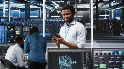Data center technician uses node tree programming interface to identify equipment performance issues. Engineer reviews data analysis graph in server hub to minimize hardware failures, camera A