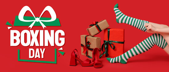 Legs of young woman in striped stockings with gift boxes and stylish high heels on red background. Christmas celebration