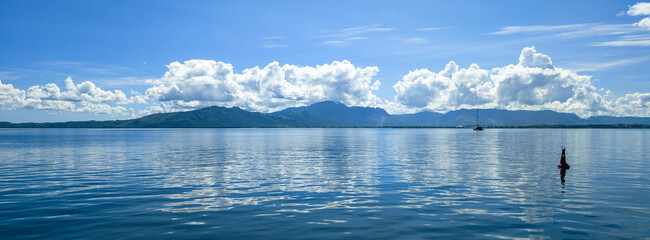 Panoramic View of Viti Levu, Fiji with a Sailboat on a Calm Sea © Cam