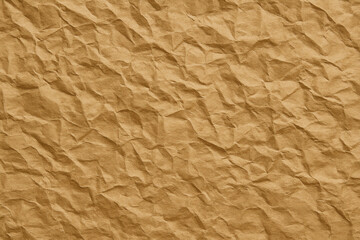 Obraz premium A textured, crumpled brown paper background, showcasing a natural and organic aesthetic with deep folds and valleys.