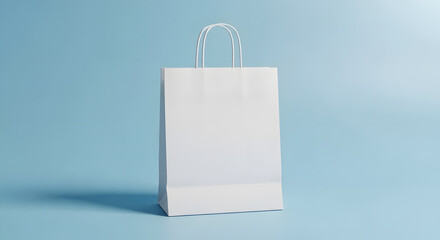 A plain white paper shopping bag with handles stands against a light blue background.