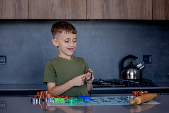 A Child Engaging in Baking Fun with Colorful Cookie Cutters in a Modern Kitchen Space