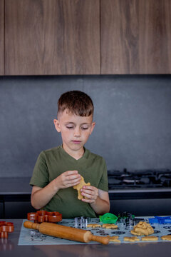 A Child Engaging in Baking Fun with Colorful Cookie Cutters in a Modern Kitchen Space