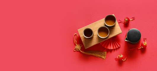 Traditional tea with Chinese symbols on red background