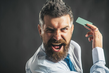 Handsome man in stylish shirt with credit or debit card. Businessman with credit card for online banking. Pay easy. Banking service. Finance, cashless payment. Business man with business card in hand.