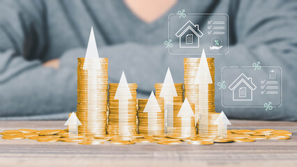 Stacks of gold coins with rising arrows and house tax icons symbolize increasing property value and...