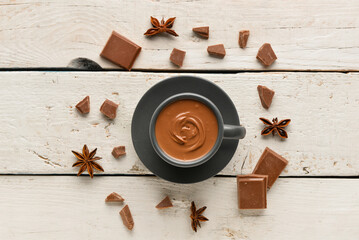 Composition with tasty melted chocolate on white wooden background