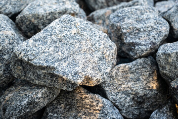 Detailed close-up of granite rocks stacked together, showing rough surface and natural stone texture.