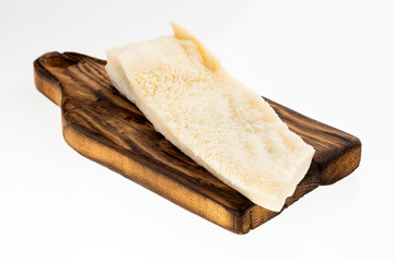 A raw honeycomb tripe in chunks on a wooden board - second beef stomach