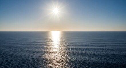 Bright sun reflecting on calm ocean horizon