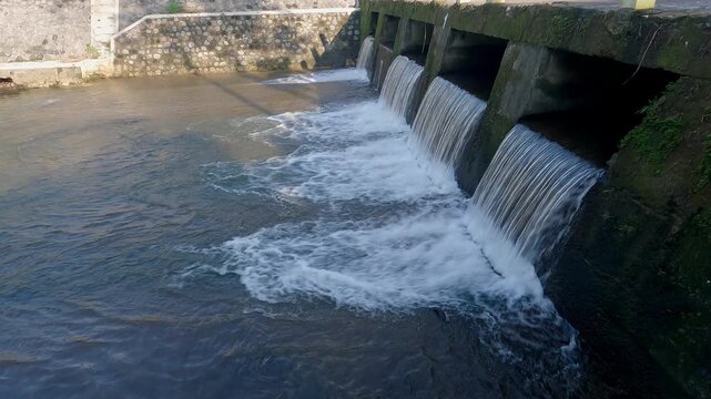 Water dam view in tropical countryside with bridge built structure. Water tunnels.
