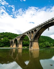 Fototapeta premium Stone arch bridge over a river