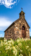 Stone chapel surrounded by wildflowers