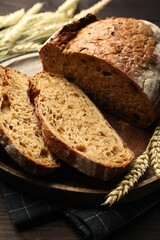 Pieces of fresh bread and spikes on table, closeup