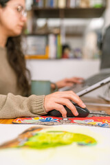 Fototapeta premium Graphic designer working from home using laptop and mouse