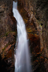 Glen Ellis Falls, a serene 64-foot plunge waterfall on the Ellis River with rugged cliffs in White Mountain National Forest
