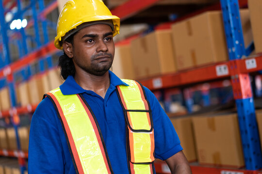 Indian warehouse worker in safety gear. Represents dedicated logistics professional and efficient industrial operations