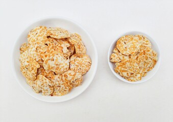 Tempeh chips in white plates on white background. Top of view. 