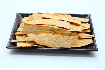 Dried Astragalus root slices used in traditional Chinese medicine.