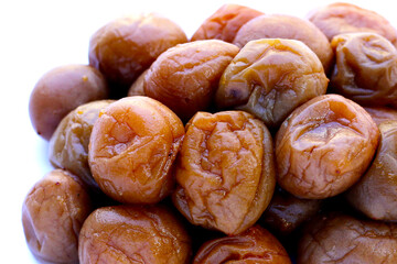 Pickled plums on white background.