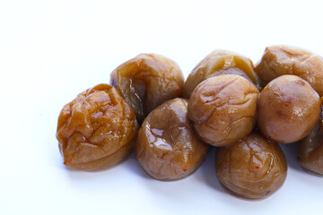 Pickled plums on white background.