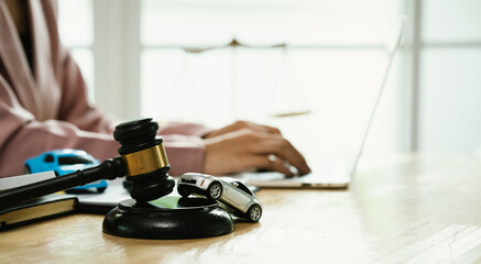 A gavel rests beside legal documents, symbolizing law, justice, court decisions, contracts, insurance claims, accidents, finance, civil cases, authority, agreements, and property-related legal judgmen