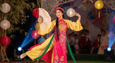 Beautiful young Vietnamese woman performing a traditional cultural dance with a fan at a night festival with lanterns.