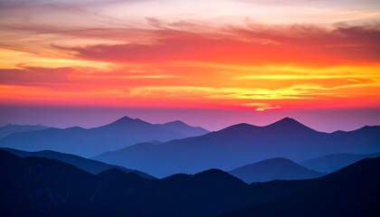 Obraz premium Vibrant Sunset Over Mountain Ranges.