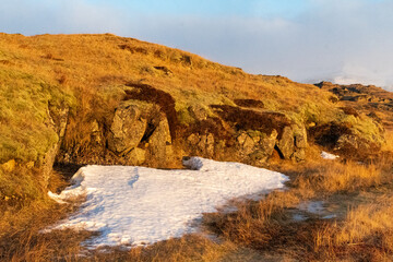 The low hanging, golden hour sun illuminates an Icelandic landscape near Djupivogur, in the south east of Iceland