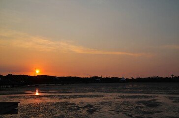Beautiful sunset with clear sky and calm waves at Utama Raya Beach, Situbondo, Indonesia