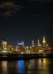 Fototapeta premium New York City at night. NYC cityscape with skyscrapers. Panoramic of New York City skyline on dusk. Manhattan skyline. New York and Hudson River. Downtown NYC. New York skyscrapers on sunset.