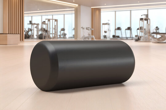 Black Foam Roller on Light Wood Floor in Modern Gym. Mock up promotion information for marketing announcements and details, blank white space.