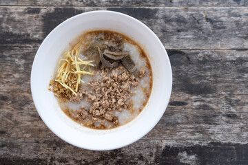 Rice porridge pork on white bowl put on wood table