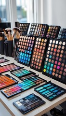Colorful Makeup Palettes and Brushes Arranged on a Wooden Desk