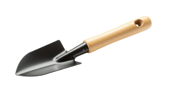 Close up of a garden trowel with a wooden handle ready for planting in a garden setting