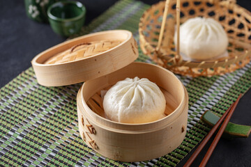 Traditional Chinese Bao Buns stuffed in a bamboo steamer